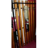A 1970s retro black painted wrought iron and teak wall mounted hall stand, having central mirror and