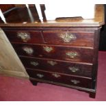 A George III oak chest of two short over three long graduated drawers, within canted corners and