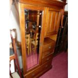 An Edwardian walnut compactum wardrobe, having single mirror door, small upper cupboard door, over