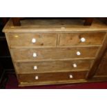 A Victorian pine round cornered chest of two short over three long graduated drawers, on bun