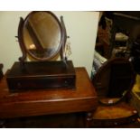 A 19th century mahogany oval swing dressing mirror, raised on bow front three drawer box base,