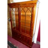 A reproduction yew wood double door glazed china display cabinet, having adjustable interior glass