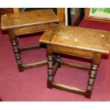 A near-pair of joined oak joint stools, each raised on bobbin turned supports to lower stretchers,