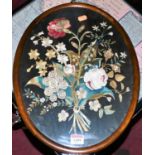 A Victorian silkwork panel depicting wild flowers in oval glazed frame, 40x30cm