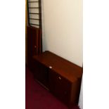 A 1970s teak single modular wall unit comprising; single twin sliding door compartment, three