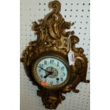 A circa 1900 Rococo Revival gilt metal cartel clock, having unsigned white enamel dial, 46cm