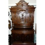 A late 19th century continental oak hunting cupboard, the upper section having panelled doors with