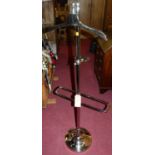 A contemporary polished chrome valet stand