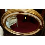 A modern gilt framed and bevelled oval wall mirror, width 85cm; and one other (2)