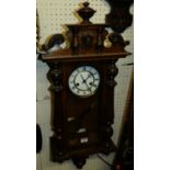 A walnut and fruitwood cased droptrunk Vienna wall clock, having unsigned dial and spring driven