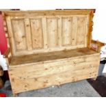 A 19th century provincial Irish boarded and panelled pine large settle, with hinged seat