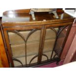 A 1930s mahogany ledgeback bow front double door glazed china display cabinet, width 102cm