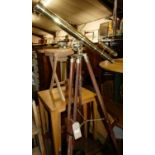 A contemporary polished brass and stained beech telescope on stand, having adjustable and rotating