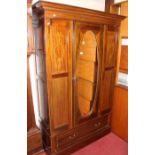 An Edwardian mahogany and chequer strung single mirror door wardrobe, having single long lower