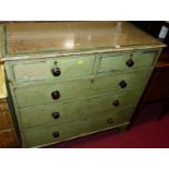 A Victorian green painted pine chest of two short over three long graduated drawers, raised on