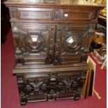 An 18th century joined and geometric moulded oak cabinet on chest, the upper long drawer over twin