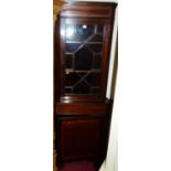 An Edwardian mahogany and satinwood crossbanded freestanding corner cabinet, with glazed upper