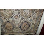 A Persian woollen cream ground Shiraz rug, the lozenge central ground decorated with stylised