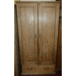 A pine double door wardrobe, enclosing a hanging rail over single long lower drawer, width 106cm