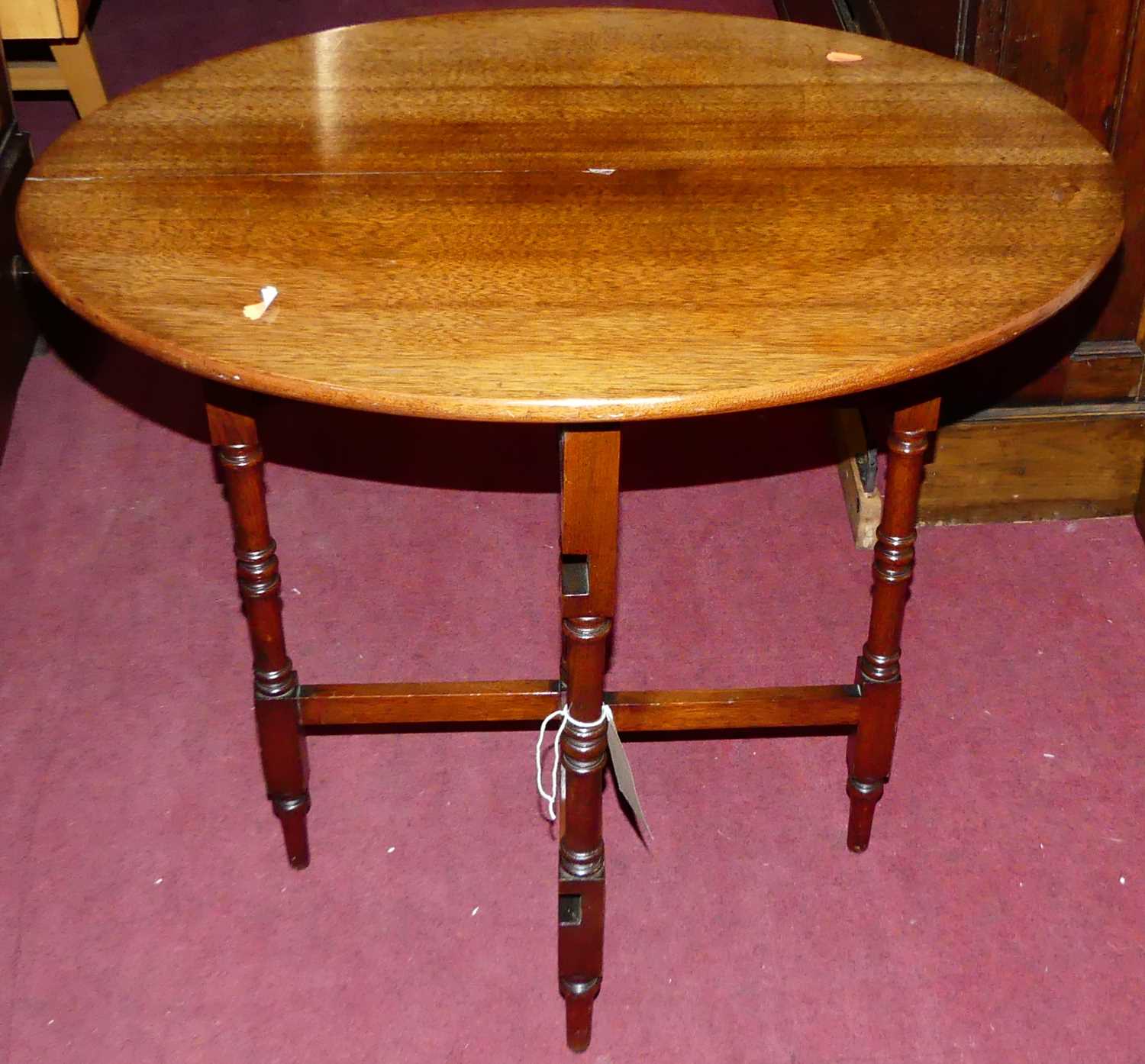 An early 20th century walnut occasional table, having turned and square cut folding base