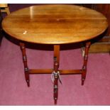 An early 20th century walnut occasional table, having turned and square cut folding base