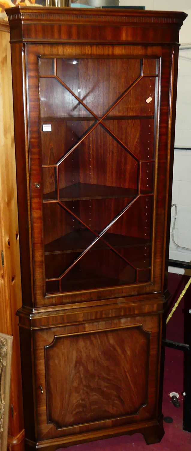 A contemporary mahogany freestanding corner cupboard, having astragal glazed single upper door, h.