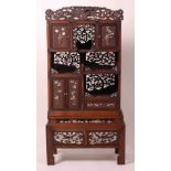 A Japanese Meiji period hardwood Shodana cabinet on stand, arranged as various cupboards and open