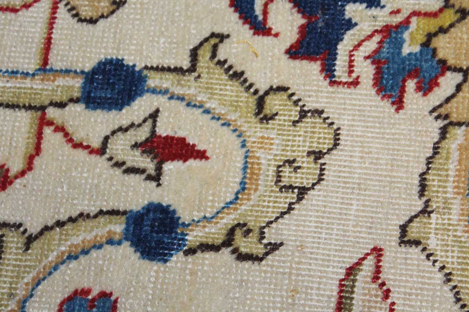 A Persian woollen cream ground carpet, decorated with scroll flowers and foliage within trailing - Image 19 of 24