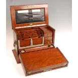 A late Victorian oak fitted stationery box by the Army & Navy, the hinged cover opening to reveal