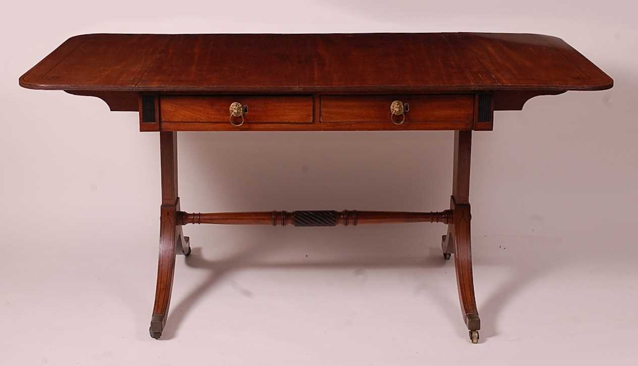 A Regency mahogany and ebony strung sofa table, having two real and two dummy frieze drawers, each