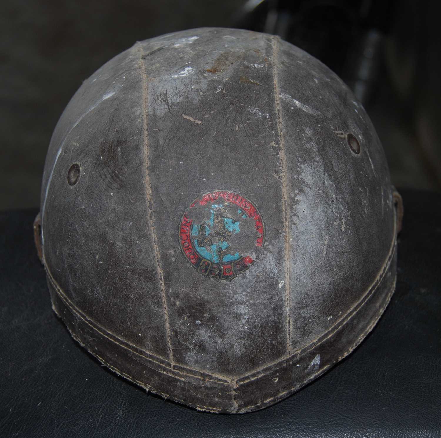 A circa 1920s leather motorcycle helmet, bearing Manx Man logo
