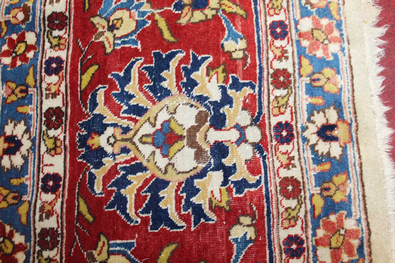 A Persian woollen cream ground carpet, decorated with scroll flowers and foliage within trailing - Image 13 of 24