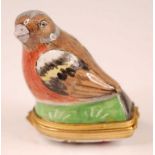 A 19th century porcelain bonbonniere in the form of a bird upon a grassy mound, the bird decorated