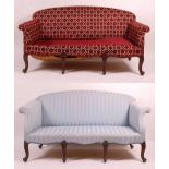 A near-pair of Victorian mahogany framed settees, each with raised backs and scroll arms, one
