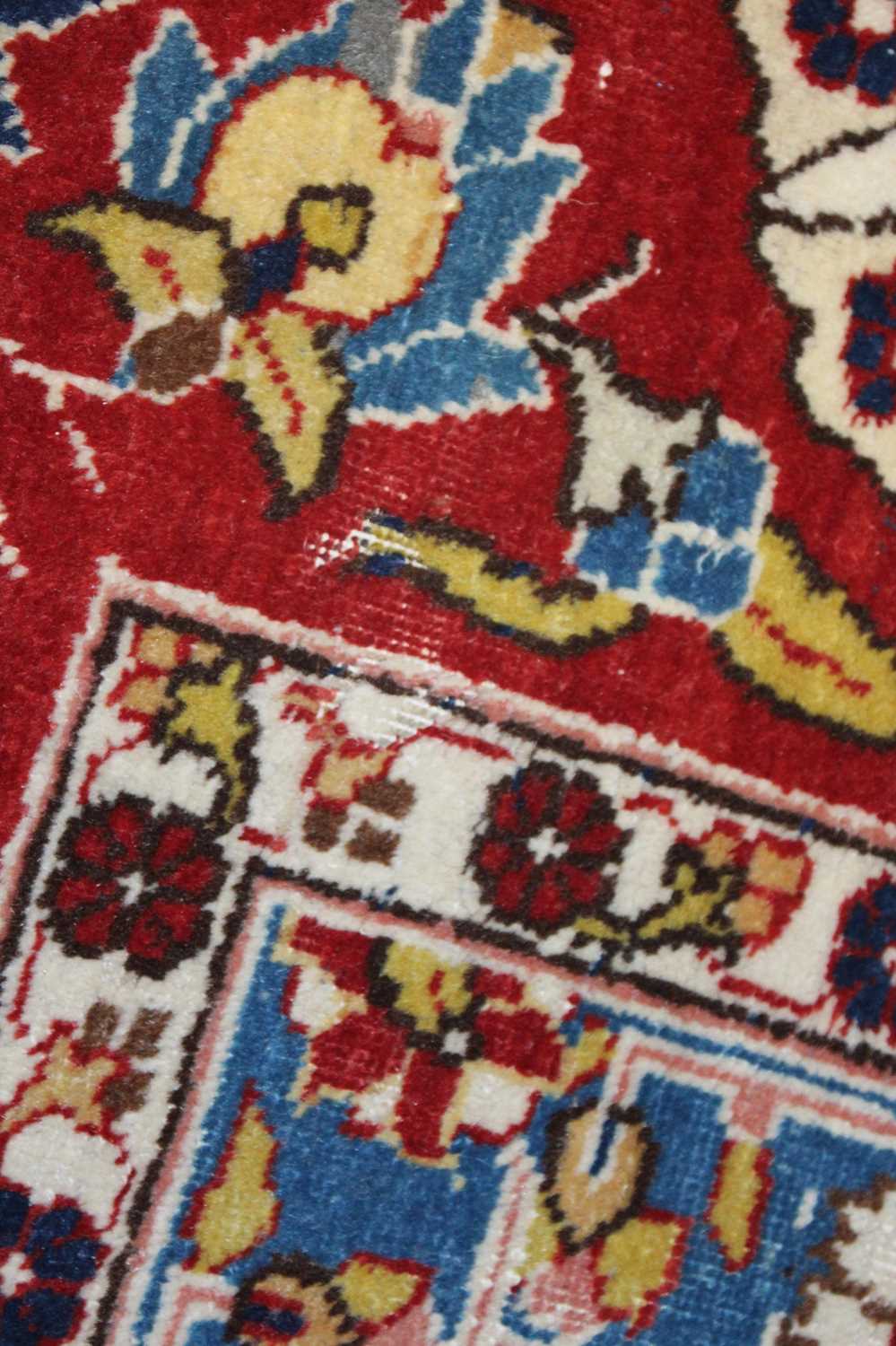 A Persian woollen cream ground carpet, decorated with scroll flowers and foliage within trailing - Image 17 of 24