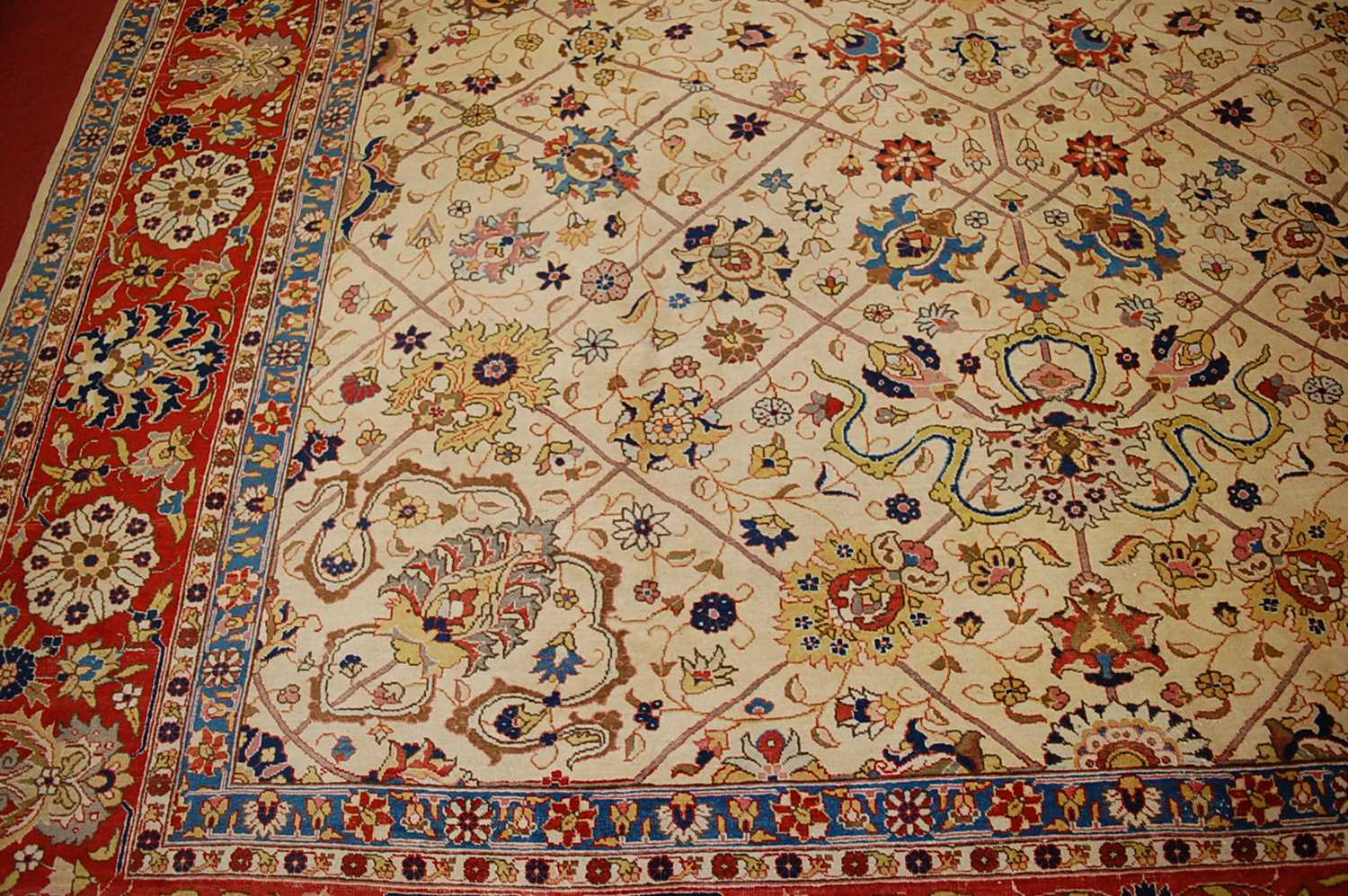 A Persian woollen cream ground carpet, decorated with scroll flowers and foliage within trailing - Image 5 of 24