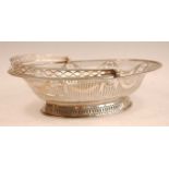 A George III silver basket, of beaded oval form, having swing carry handle, the pierced frieze