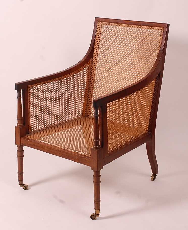 A 19th century mahogany Bergere library chair, having split cane back, side and seat, raised on ring - Image 5 of 10