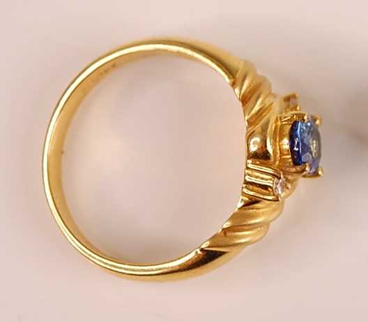 An 18ct gold Ceylon sapphire and diamond set ring, the four claw set oval cut sapphire weighing - Image 3 of 3