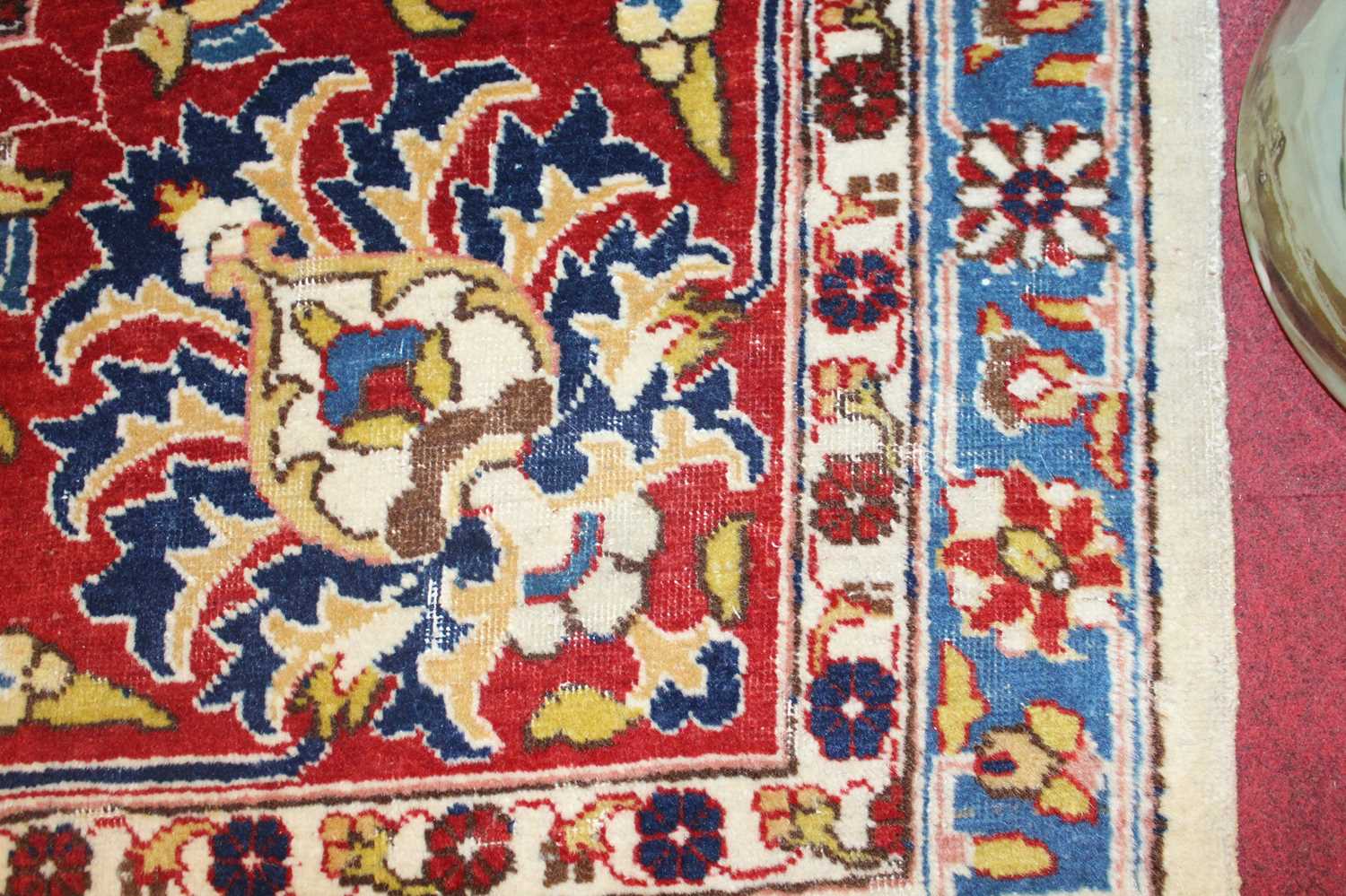 A Persian woollen cream ground carpet, decorated with scroll flowers and foliage within trailing - Image 14 of 24