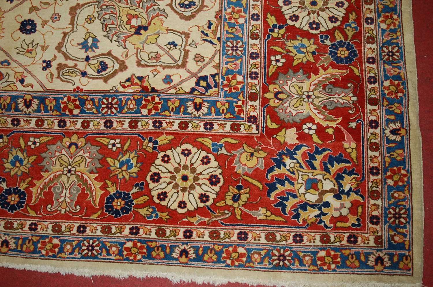 A Persian woollen cream ground carpet, decorated with scroll flowers and foliage within trailing - Image 3 of 24