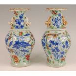 A pair of 19th century Chinese stoneware celadon ground vases, each enamel decorated with exotic