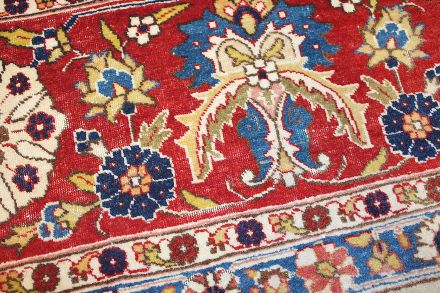 A Persian woollen cream ground carpet, decorated with scroll flowers and foliage within trailing - Image 16 of 24