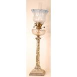 A late Victorian silver plated oil lamp, having an acid etched and blue tinted glass shade, cut