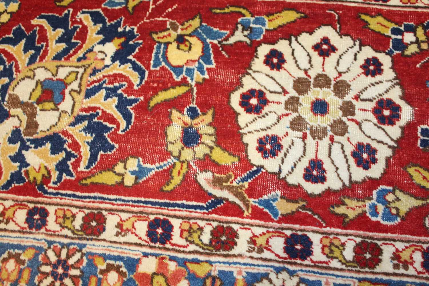 A Persian woollen cream ground carpet, decorated with scroll flowers and foliage within trailing - Image 15 of 24