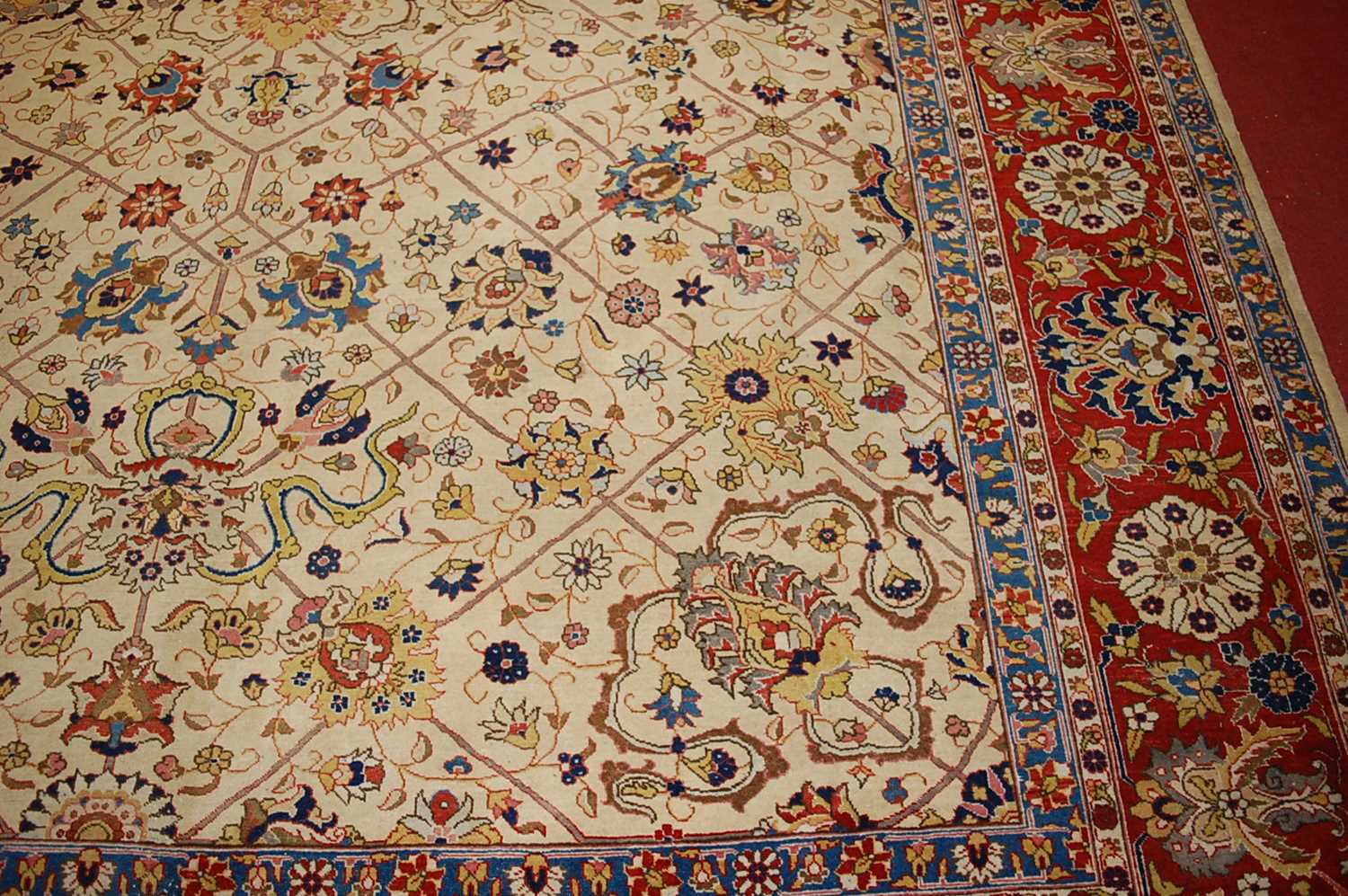 A Persian woollen cream ground carpet, decorated with scroll flowers and foliage within trailing - Image 6 of 24