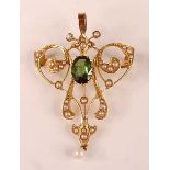 An Edwardian yellow metal, peridot and seed pearl set openwork pendant, comprising a centre oval