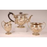 An Edwardian silver bachelors three-piece tea set, comprising teapot, twin handled sugar and