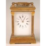 A circa 1900 French lacquered brass carriage clock, having an unsigned white enamel Roman and Arabic