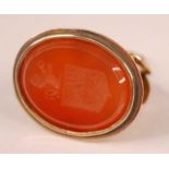 A yellow metal carnelian fob seal, the oval carnelian intaglio measuring approx 30 x 23mm, depicting